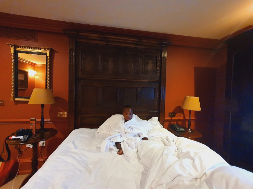 Lewis in a robe on the bed