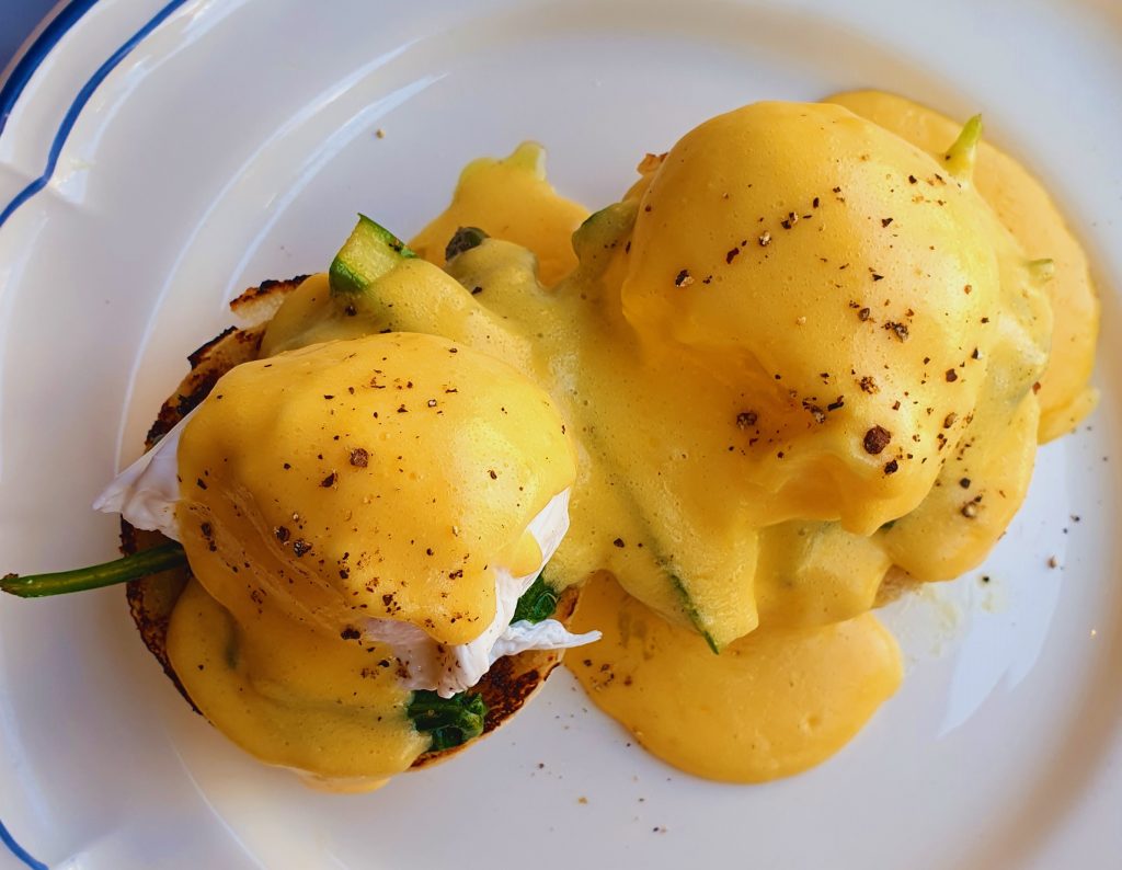 Plate of eggs benedict with hollandaise sauce